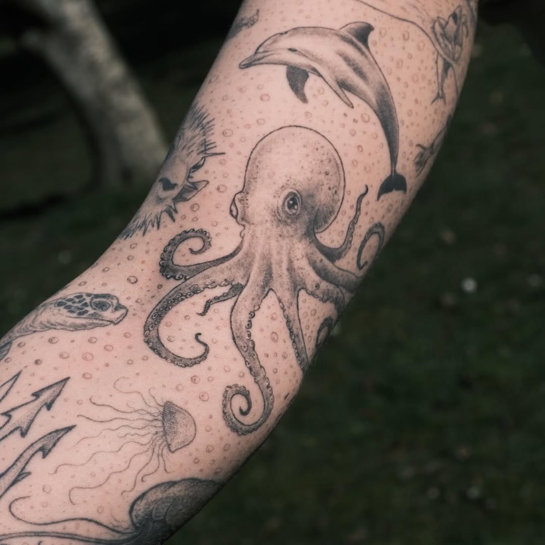 Wildlife tattoo featuring an octopus and dolphin